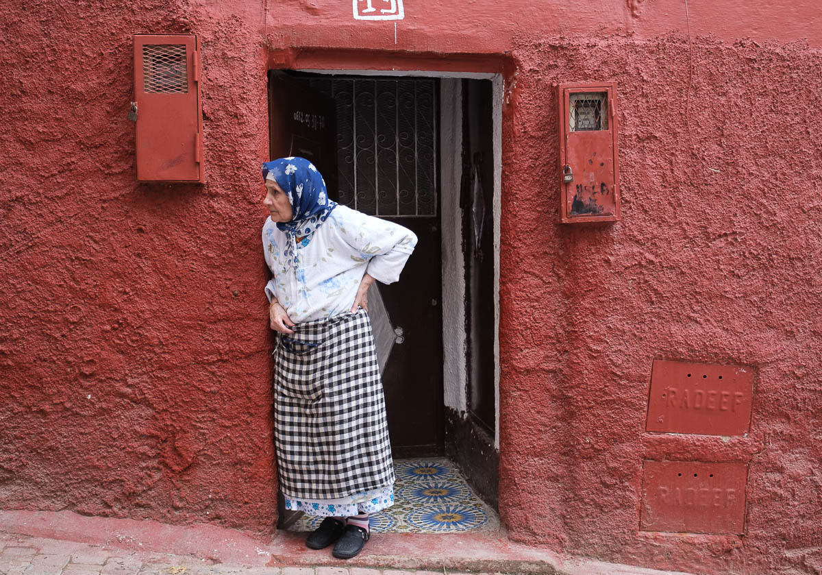 A lady in the jewish quarter of FES standing in the doorway of her house
